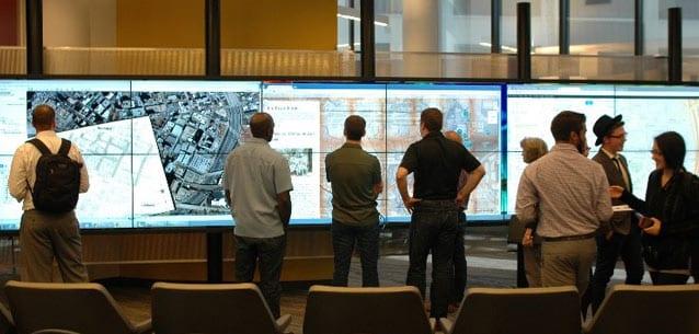Students and faculty gather around the interactWall